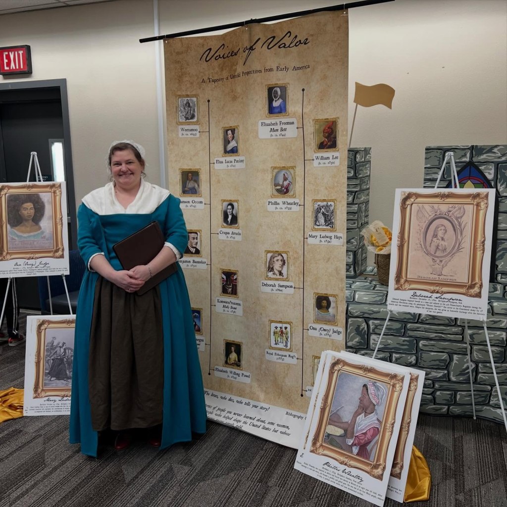a woman stands in front of a display